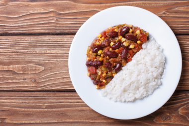 Chili con carne and rice on a white plate top view