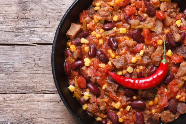 Chili con carne close-up in a frying pan top view — Stock Photo, Image