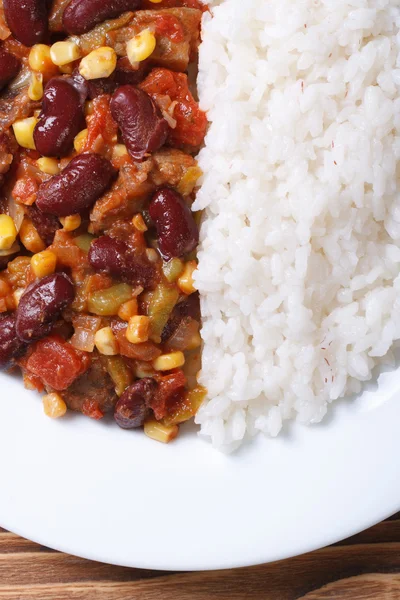 Chili con carne and rice on a white plate macro vertical — Stock Photo, Image