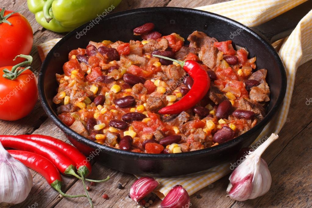 Chili con carne close-up in a frying pan with the ingredients. — Stock ...