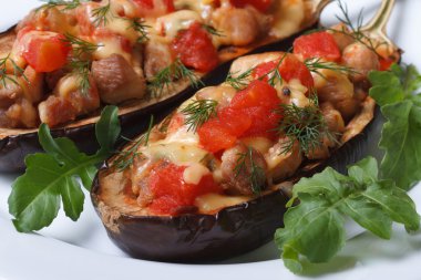 et, peynir ve domates ile iki yarı pişmiş patlıcan