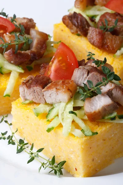 Pieces of polenta with bacon and vegetables macro vertical — Stock Photo, Image