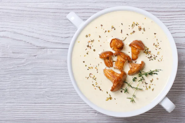 Cream soup with mushrooms chanterelles and herbs top view — Stock Image Cream soup with mushrooms chanterelles and herbs top view Stock Photo