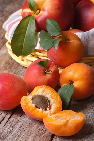 Apricots close-up on a background of a basket of fruit  vertical — Stock Photo, Image