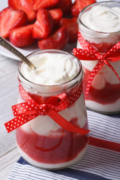 Yogurt with strawberries in a glass jar vertical — Stock Photo, Image