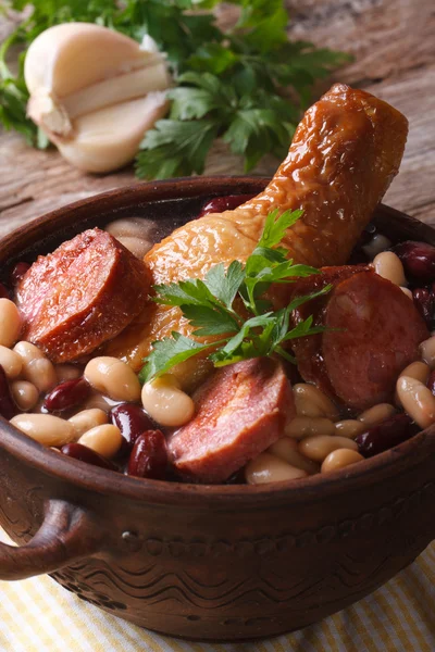 Soup with beans, chicken legs and sausages close up vertical — Stock Image Soup with beans, chicken legs and sausages close up vertical Royalty Free Stock Photos