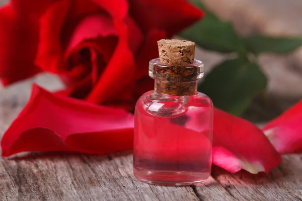 Fragrant rose oil in a bottle horizontal macro — Stock Photo, Image