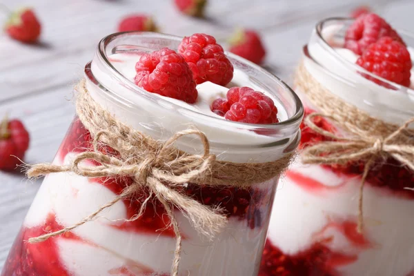 Fresh raspberry yogurt in a glass jar closeup horizontal — Stock Photo, Image