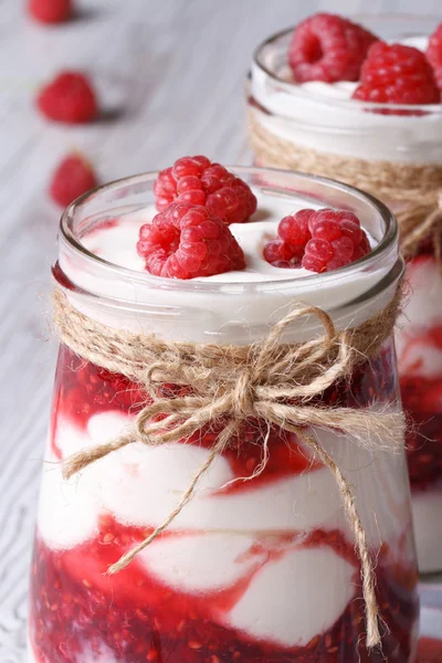 Fresh raspberry yogurt in a glass jar vertical — Stock Photo, Image