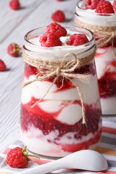 Raspberry yogurt in a glass jar closeup vertical — Stock Photo, Image
