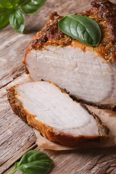 Sliced roast pork tenderloin and basil close-up vertical — Stock Photo, Image