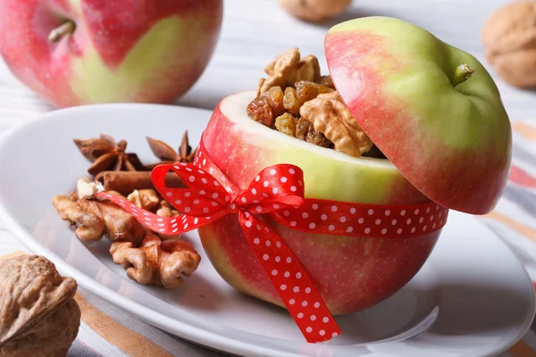 Red apple stuffed with nuts and raisins close up horizontal — Stock Photo, Image