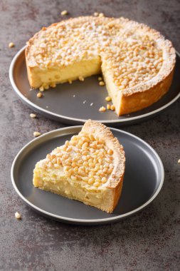 Çam fıstıklı kremalı pasta. Torta della nonna ya da büyükannenin pastası. Masadaki tabağa yakın. Dikey