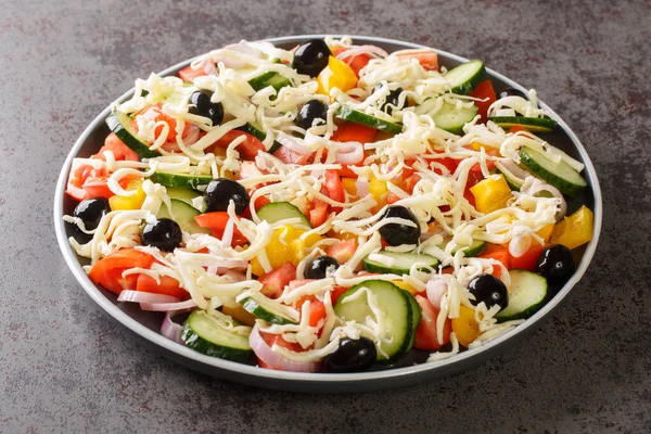 Shopska salata vegetables Chopped Salad with cheese closeup in the plate on the table. Horizonta