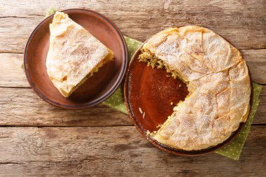 Chicken Bastilla pastilla shredded chicken with aromatic spices wrapped in perfectly crisp pastry layers closeup in the plate on the table. Horizontal top view from abov