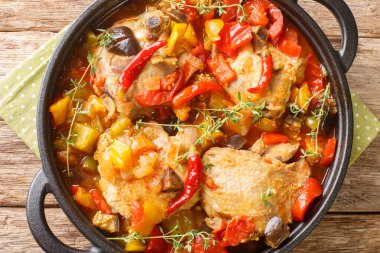 African Ivory Coast Style Kedjenou Chicken Stew with vegetables closeup in the pan on the table. Horizontal top view from abov