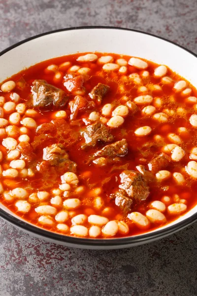 Turkish White Bean Stew With Meat closeup in the plate on the table. Vertica