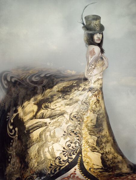 Beautiful artistic portrait of an extravagant lady in an eighteen century style dress and cylinder with clouds in the background