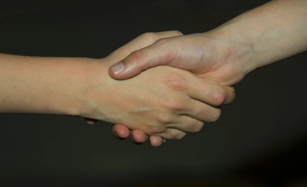 two children shake hands