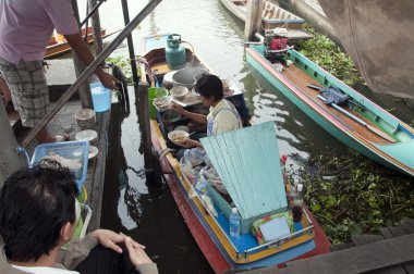 BANGKOK - 28 March 2011 : Woman selling food on the river on Mar clipart