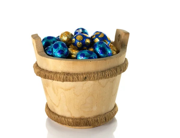 Wooden bucket with easter eggs — Stock Photo, Image