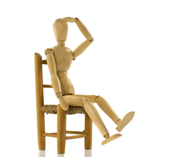 Wooden puppet on chair — Stock Photo, Image