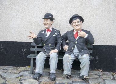 laurel and hardy sitting on a bench clipart