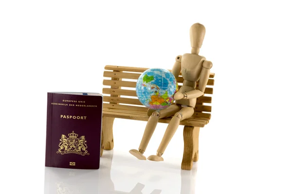 Passport globe and man on bench — Stock Photo, Image