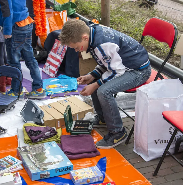 Boy counting his earned money on queensday market — Stock Photo, Image