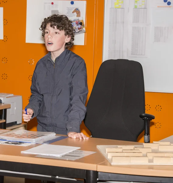 Boy talking in classroom — Stock Photo, Image