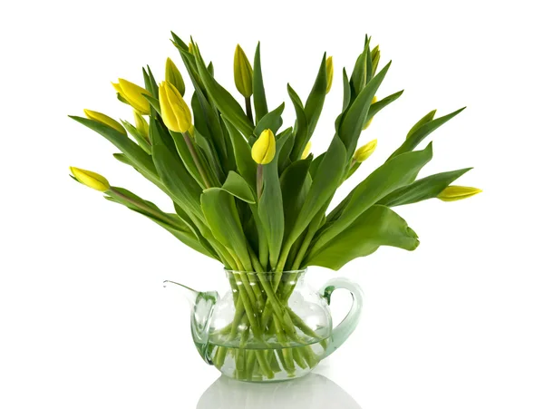 Glass teapot with yellow tulips — Stock Photo, Image