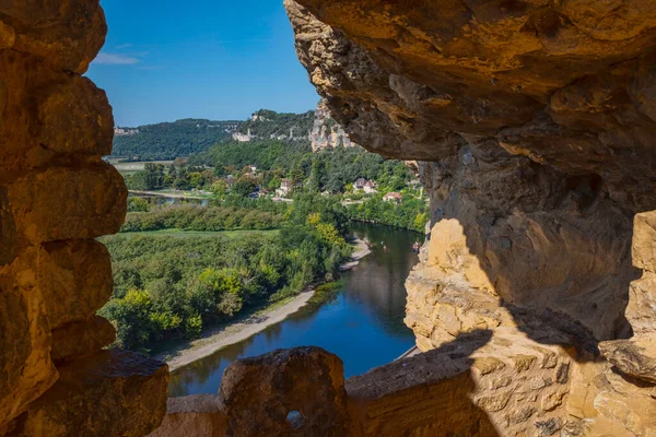 cliffs of lime rock above the river the dordogne in france from the area Domme with boats on the river