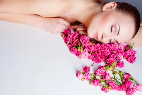 Frau mit Rosenblüten — Stockfoto