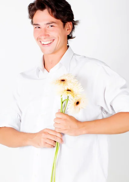 Mladý muž s květinami — Stock fotografie
