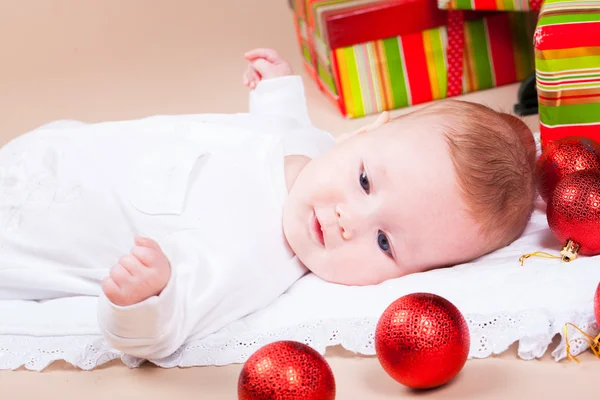 Baby under christmas pine — Stock Photo, Image