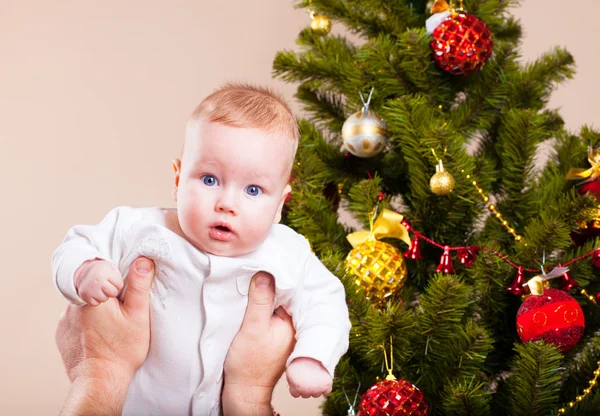 Baby near christmas pine — Stock Photo, Image