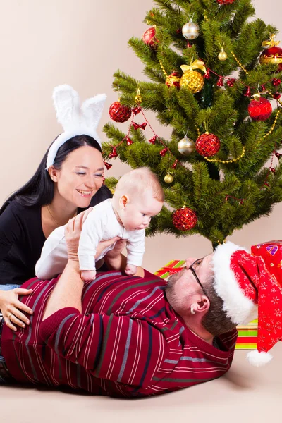 Family near christmas pine — Stock Photo, Image