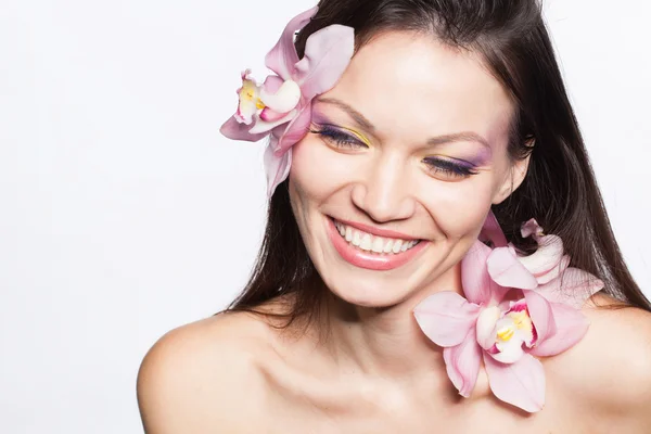 Girl with orchid flowers in hair — Stock Photo, Image