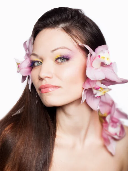 Girl with orchid in hair — Stock Photo, Image