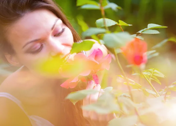 Mulher perto rosa flor — Fotografia de Stock