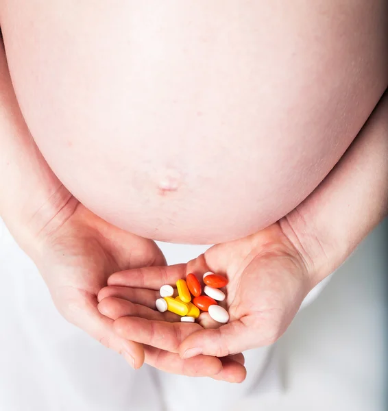 Pregnant woman with tablets