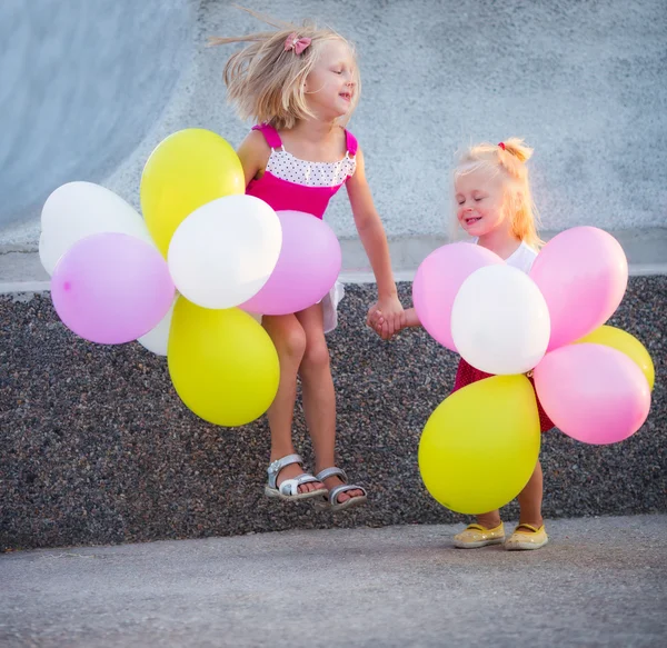 Two little girls with balloons — Stock Photo, Image