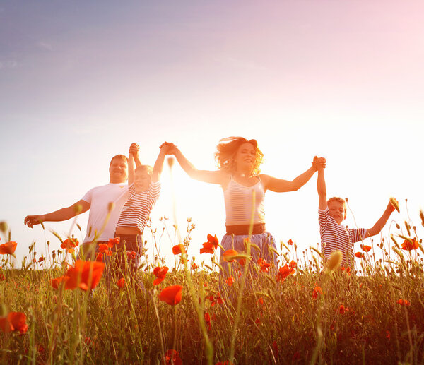 Family playing on the meadow