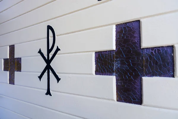 Cross shaped glass window of a church door