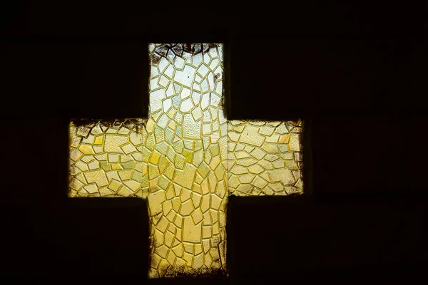 Cross shaped glass window of a church door