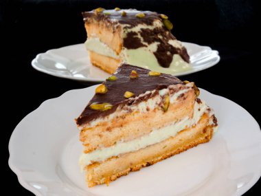 Pistachio cream cake on a white dish