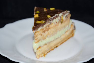 Pistachio cream cake on a white dish