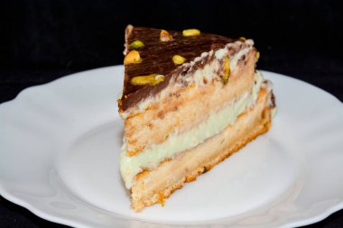 Pistachio cream cake on a white dish