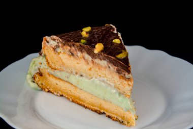 Pistachio cream cake on a white dish