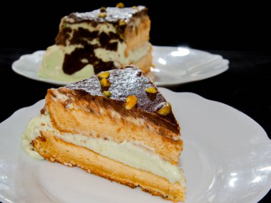 Pistachio cream cake on a white dish